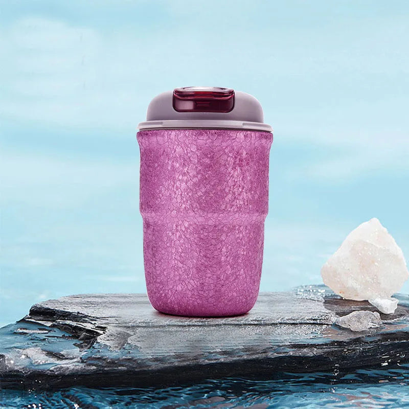 Pink titanium belly flask with leakproof lid placed on rock surface ideal for hiking, fishing, and camping