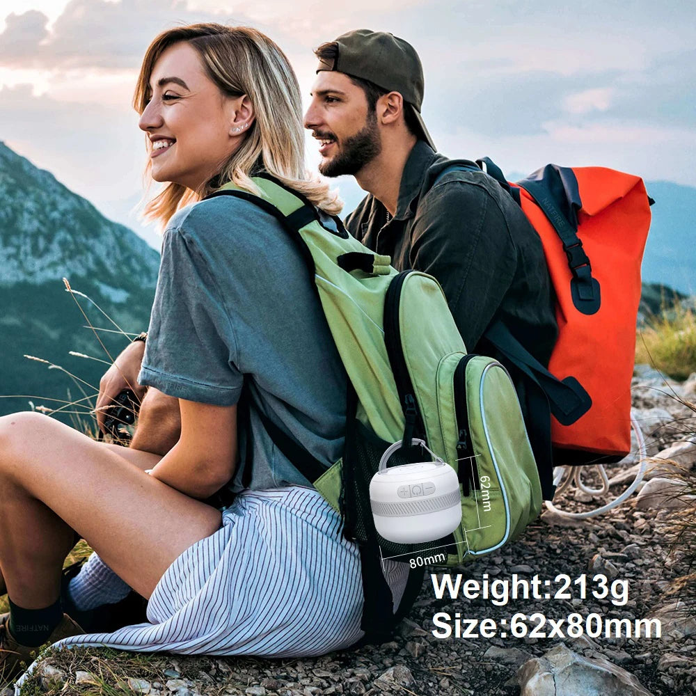 Portable LED lantern beside hikers outdoors