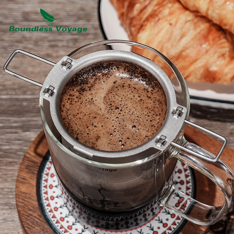 Titanium coffee filter resting on a ceramic mug during brewing, ideal for travel and outdoor coffee setups