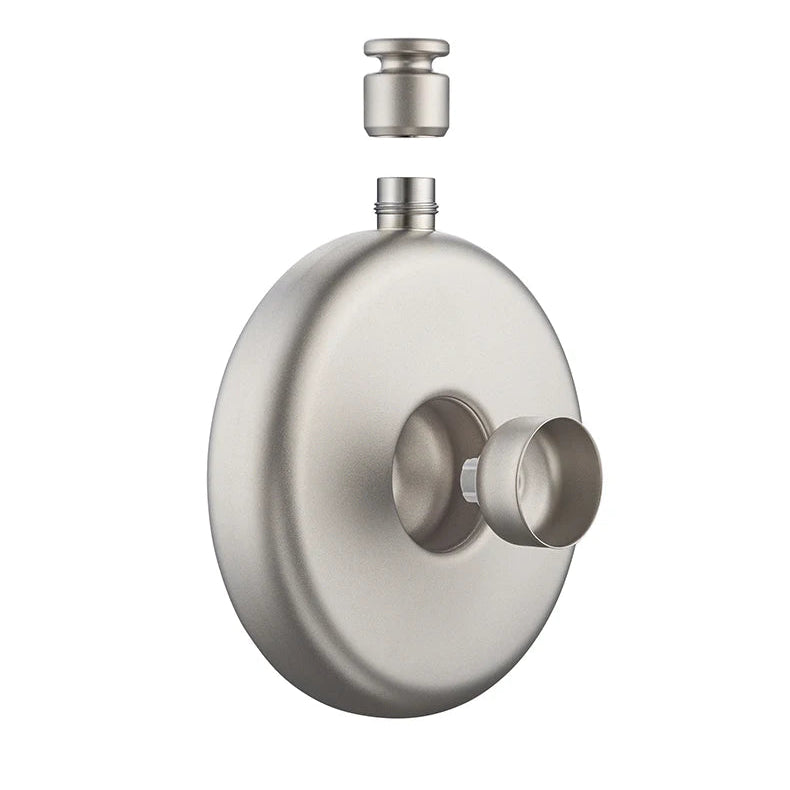Side view of round titanium flask with cap