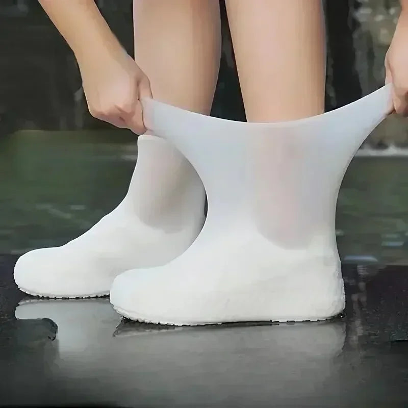 White silicone shoe covers worn outdoors for rain protection