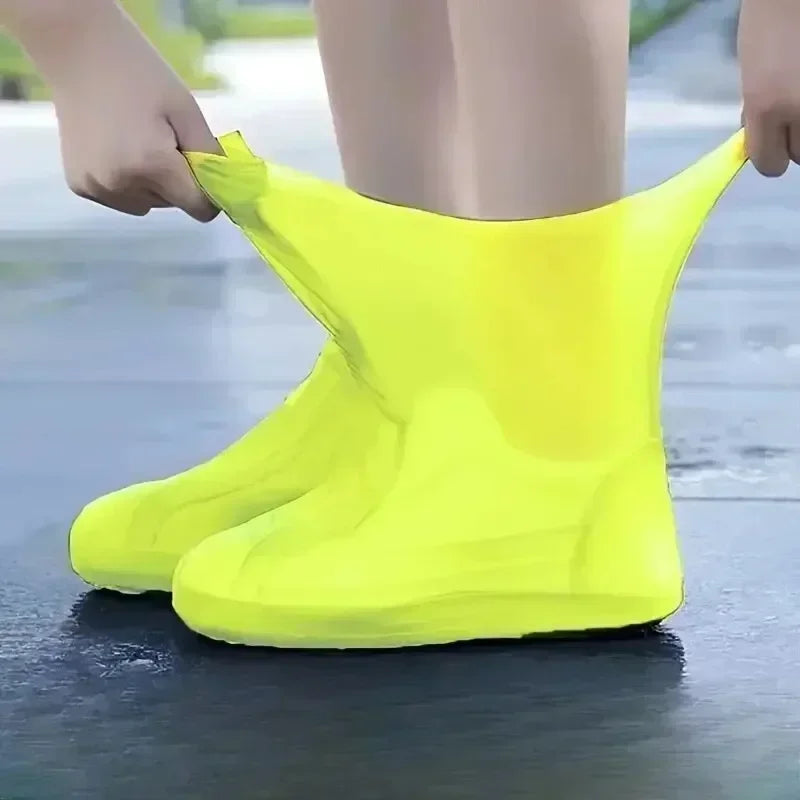 Yellow silicone shoe covers worn outdoors on wet ground