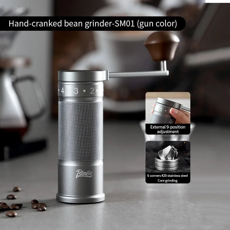 Stainless steel manual coffee grinder with visible burr and fine coffee grounds for precision grind