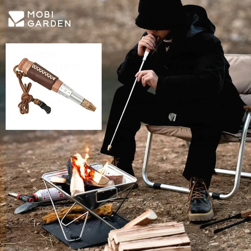 Person using telescopic fire blow tube at campfire