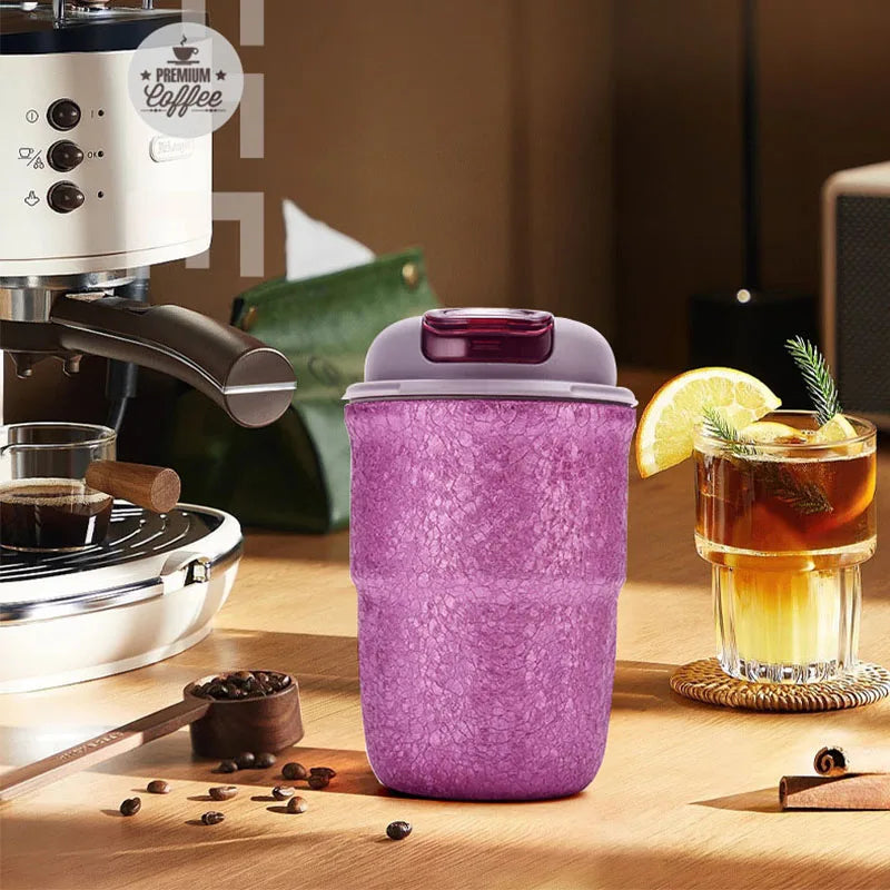 Purple titanium belly cup flask beside espresso machine and drink glass, ideal for travel, work, or outdoor use