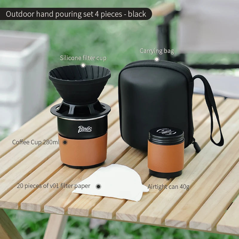 Four-piece titanium camping coffee kit including kettle, dripper, grinder, and mug in black finish