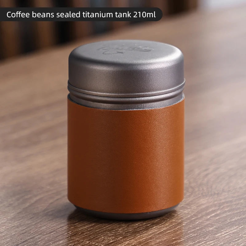 Titanium coffee canister standing on wooden surface showing minimalist portable design