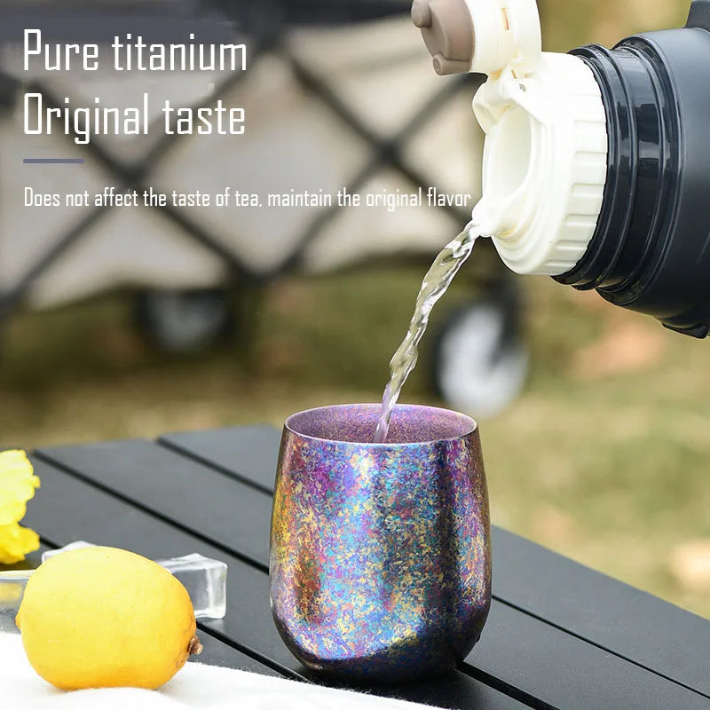 Drink being poured into titanium cup outdoors