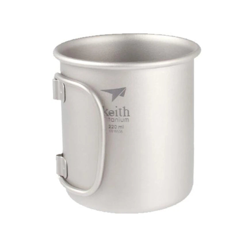 Titanium mug showing folding handle mechanism