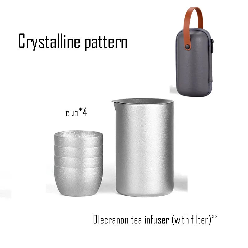 Titanium tea infuser and crystalline pattern cups beside leather travel case designed for minimalist brewing
