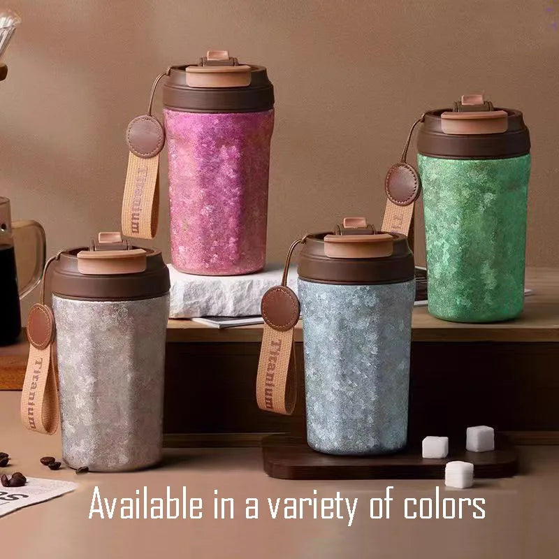 Titanium thermos cups in pink, blue, green, and silver arranged side by side showing available colour options
