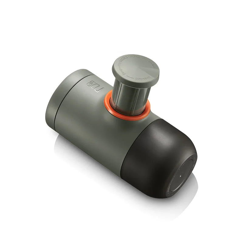 Compact travel espresso machine showing manual pump and minimalist design for outdoor use