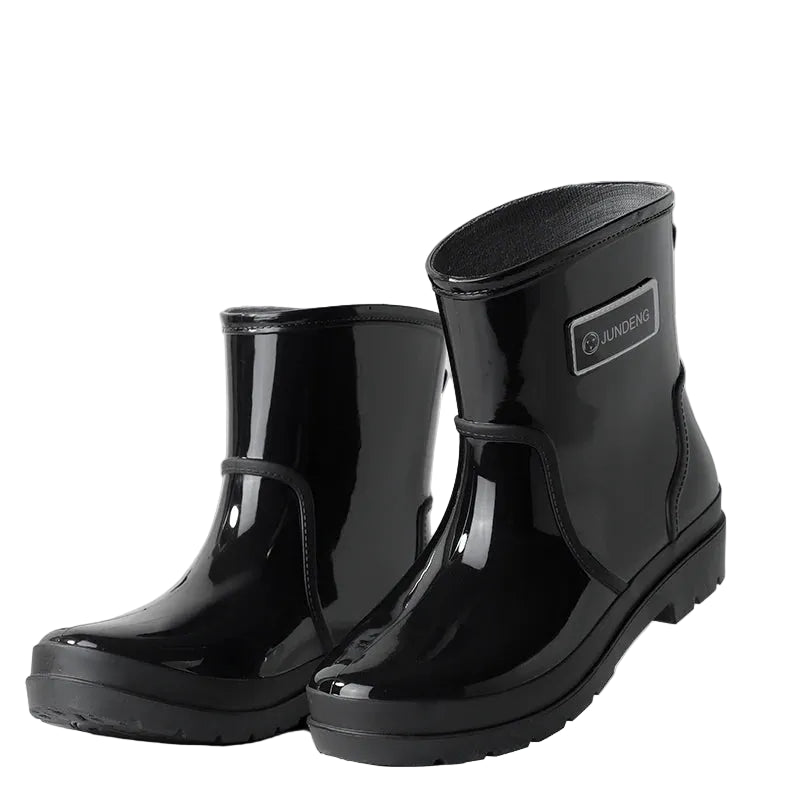 Black women’s ankle gumboots pair showing flat sole and shape