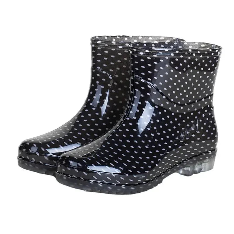 Black women’s ankle gumboots with white polka dots shown as pair