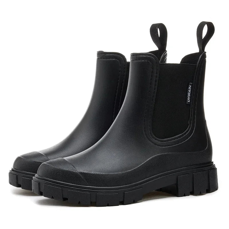 Women’s Chelsea ankle rain boots in black with platform sole side view