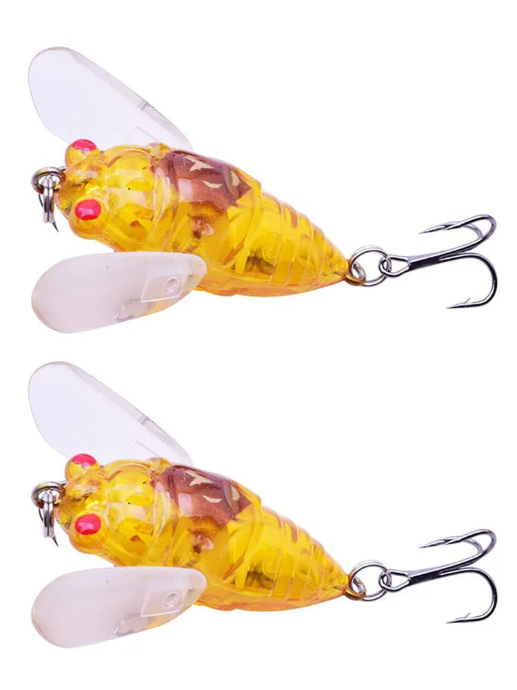 Two yellow and orange cicada-style fishing lures shown side by side